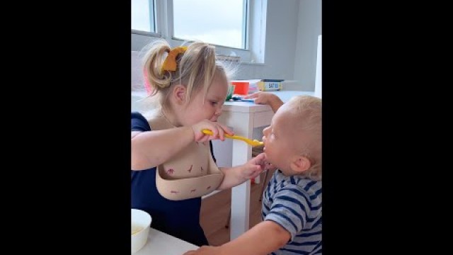 'Cute Toddler Naomi helps to eat baby David his food'