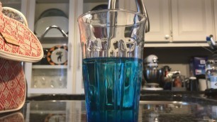 'Blue food colouring mixing with water'