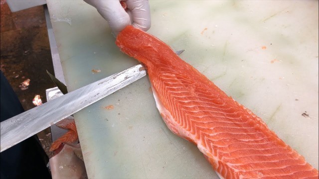 'Japanese Street Food - SALMON SASHIMI Japanese delicacy consisting of fresh raw fish'