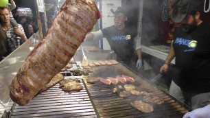 'Huge Grill of Beef and Sausages from Argentina. Italy Street Food Festival'