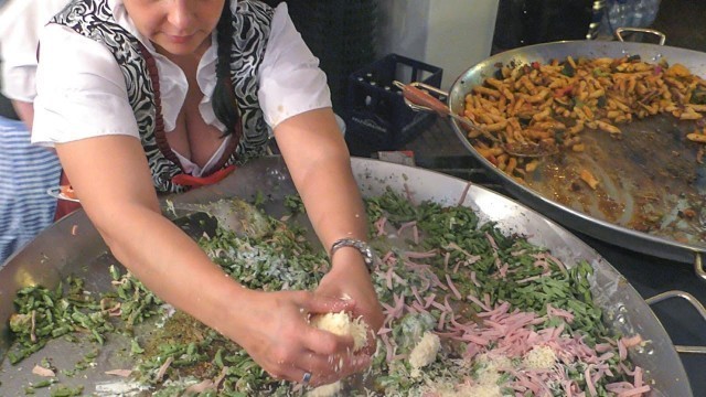 'Two Women Master Huge Pans of Austrian Food. Italy Street Food Fair'