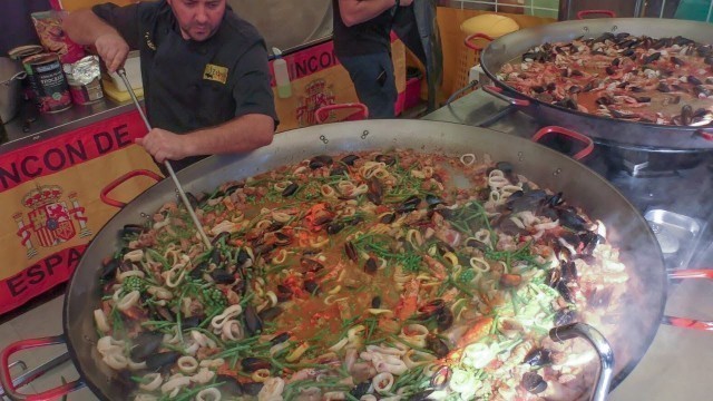 'Many Huge Pans Cooking Spanish Paella. Street Food Fair in Italy'