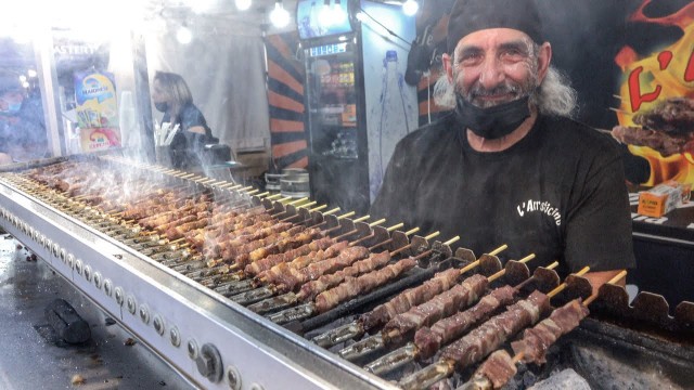 'Italy Street Food Fair. Small Sticks of Sheep Meat Roasted on Charcoal. \"Arrosticini\"'