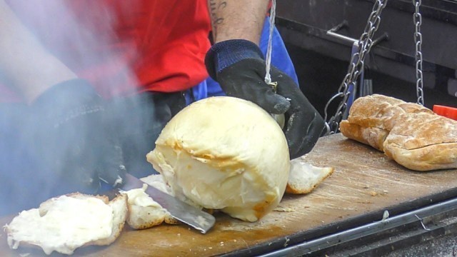 'Hanged Cheese \'Caciocavallo\' Grilled and Melted on Bread. Italy Street Food'