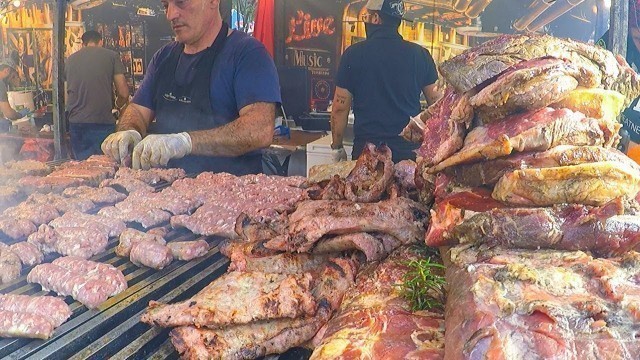 'Grilled Meat Roasted Texas Style. Juicy Pork Loin, Ribs and more. Street Food Fair in Italy'