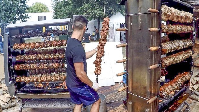 'Huge Skewers with Pig Legs on Big Grills. Italy Street Food'