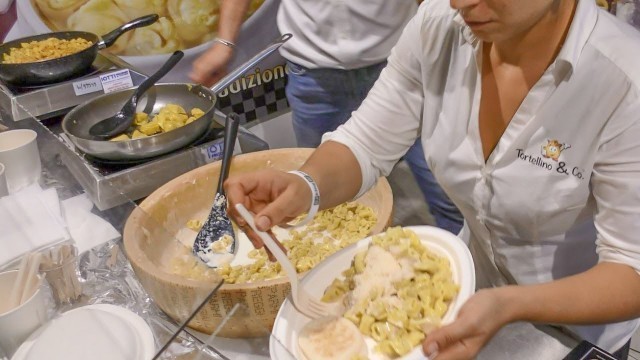 'Dumplings Drowned in Melted Parmesan Cheese Wheel. Italy Street Food'