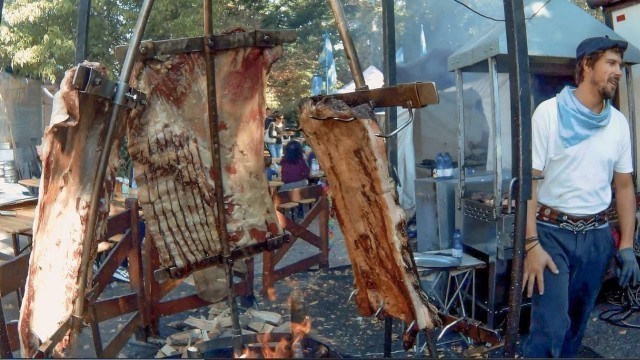 'Italy Street Food Festival. Huge Asado, Mixed Meat on Grill, Angus and more Food from the World'