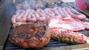 'Italy Street Food Festival. Huge Asado, Blocks of Meat on Grill, Big Sausages, Ham and more Food'