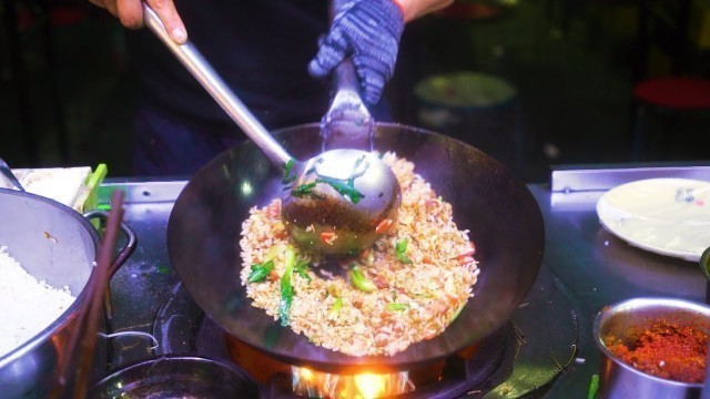 'Chinese Street Food -Night market egg fried rice fried noodles, grilled seafood on iron plate'