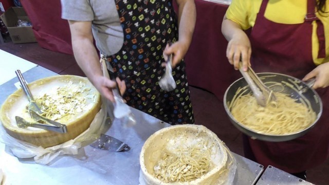 'Spaghetti and Rice Hand Rolled in a Cheese Wheel. Italy Street Food'