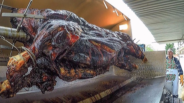 'Italian Grill Master Roasts and Cuts WHOLE Bull. Italy Street Food Festival'