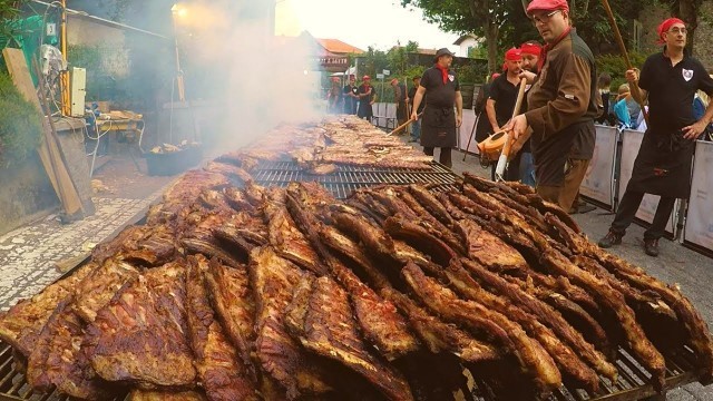 'Italy Street Food. Melted Cheese on Pretzel, Huge Grill of Ribs, Pork Meat for Sandwich, more Food'